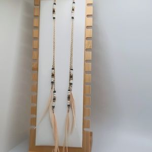 Gorgeous long statement feather earrings in cream, black, white and gold.